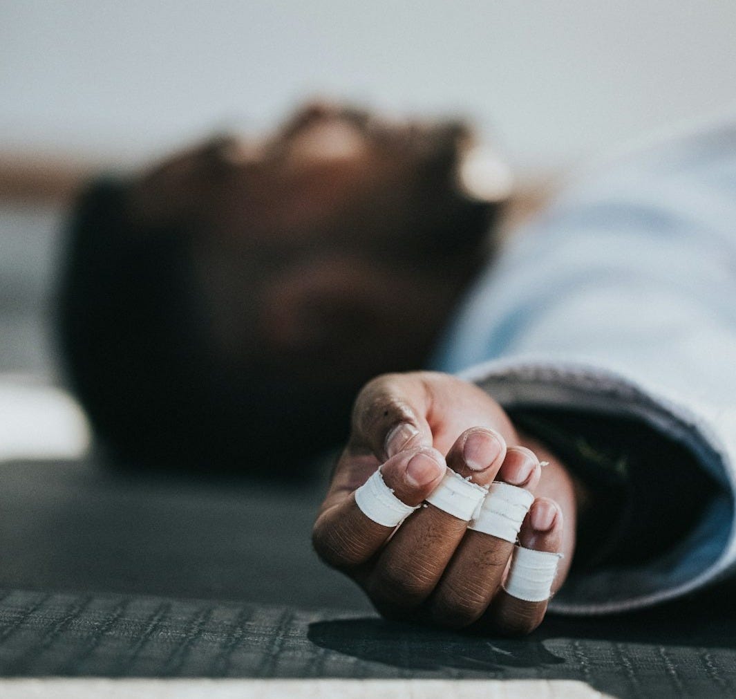 man in blue and white striped long sleeve shirt lying on floor man in blue and white striped long sleeve shirt lying on floor