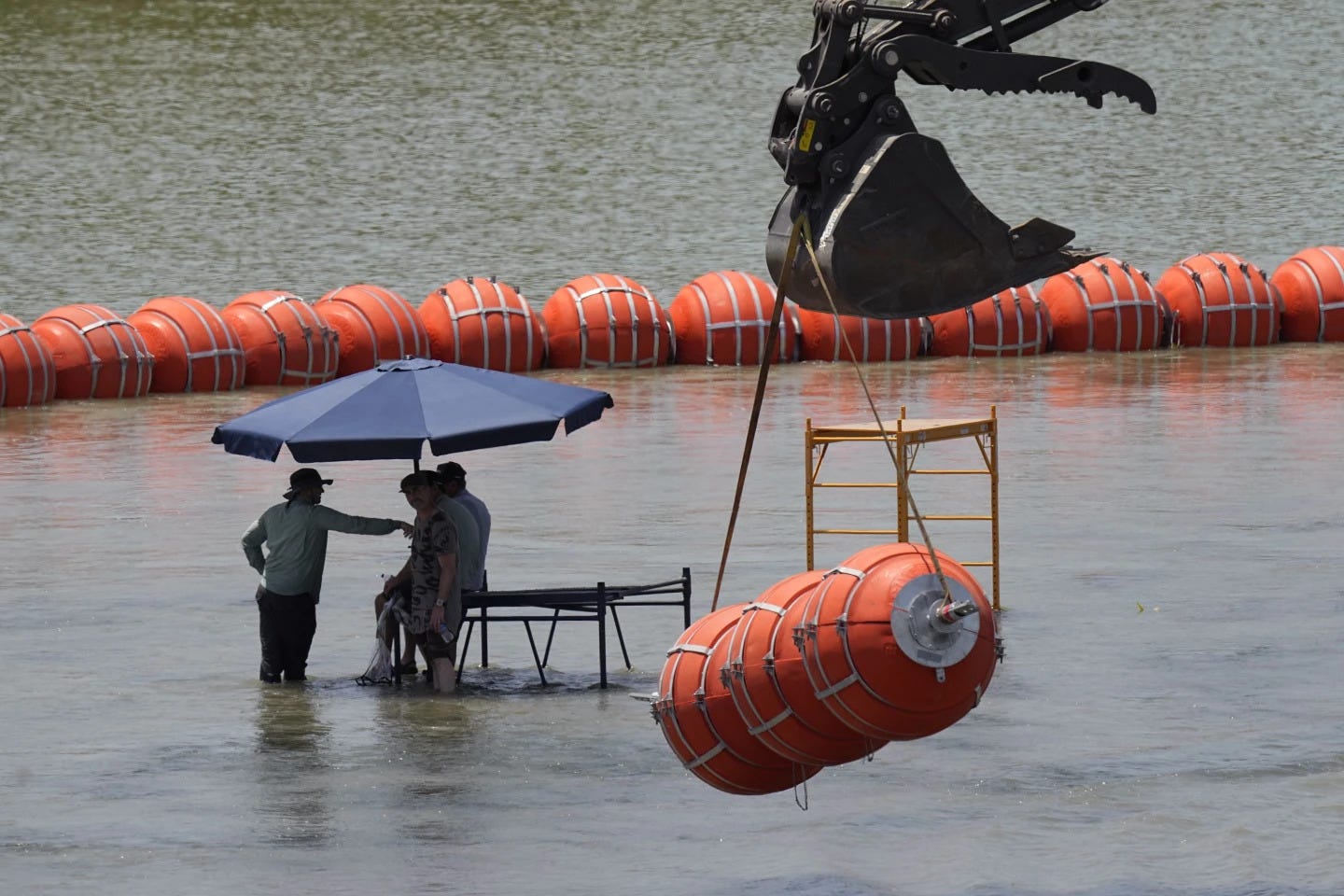 Dead body found stuck to Texas Gov. Greg Abbott's border buoys in Rio Grande  – Houston Public Media