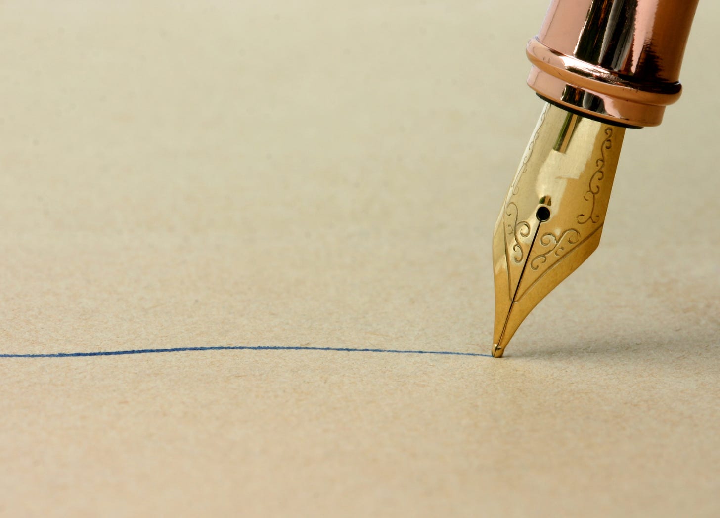 Close-up of a Victorian gold fountain pen tip writing a single line in ink on paper, evoking the intimacy and revelation of prose style.
