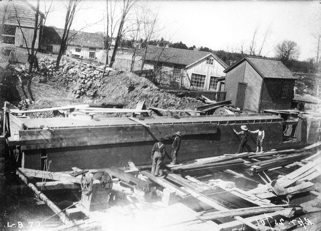 Four individuals working on the construction of lock 32