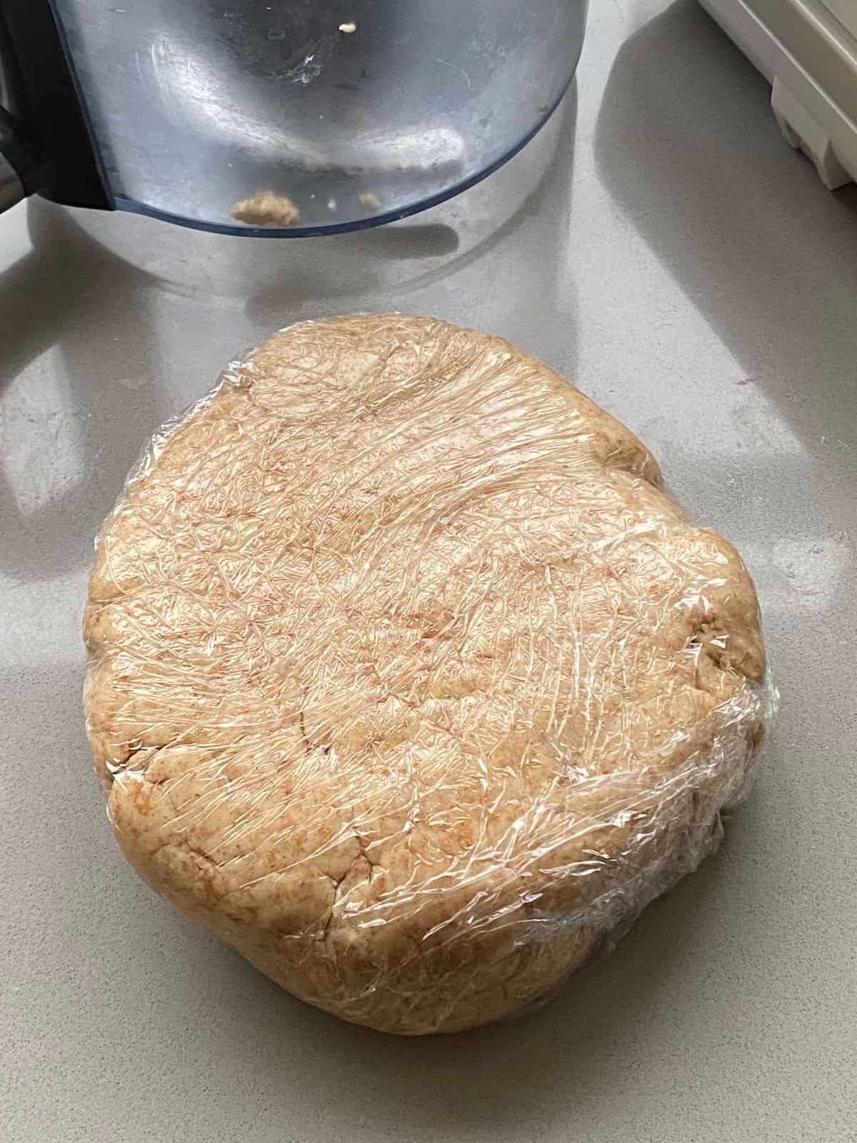 Psastry dough wrapped in clingfilm. Shortcrust pastry wrapped in cling film.