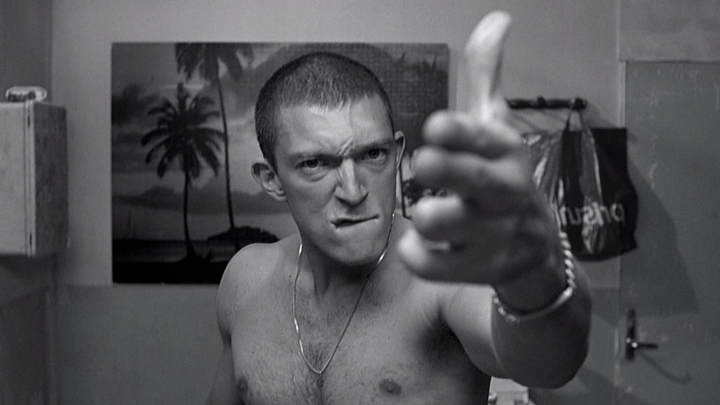 La Haine | Still features Vincent Cassel as Vinz making a finger gun.