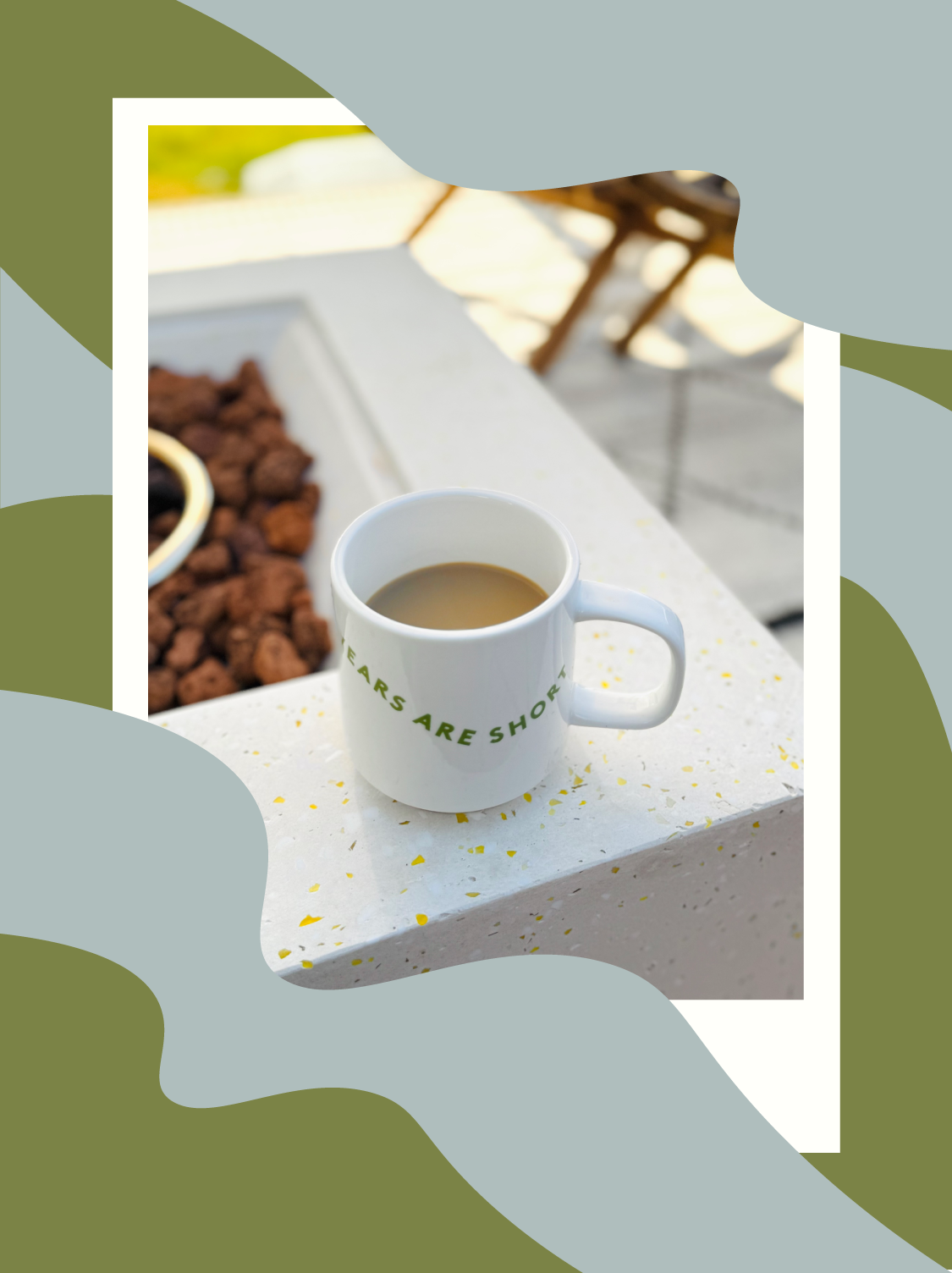 mug of coffee sitting on the edge of a fire pit