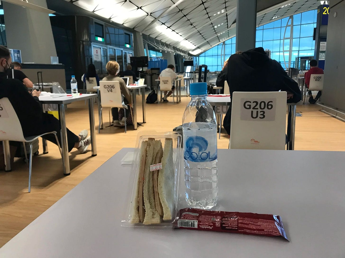 Waiting for PCR test results with the provided snacks and social distanced tables and chairs at Hong Kong Airport upon return from France Waiting for PCR test results with the provided snacks and social distanced tables and chairs at Hong Kong Airport upon return from France