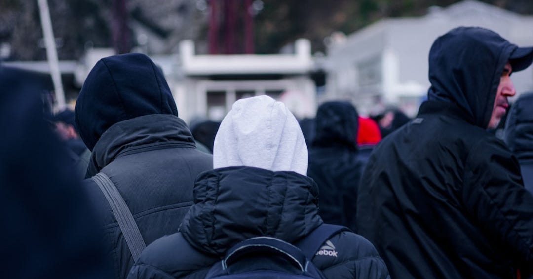 a group of people in winter coats a group of people in winter coats