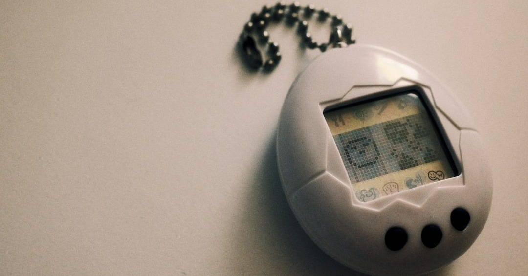 a small electronic device with a chain attached to it