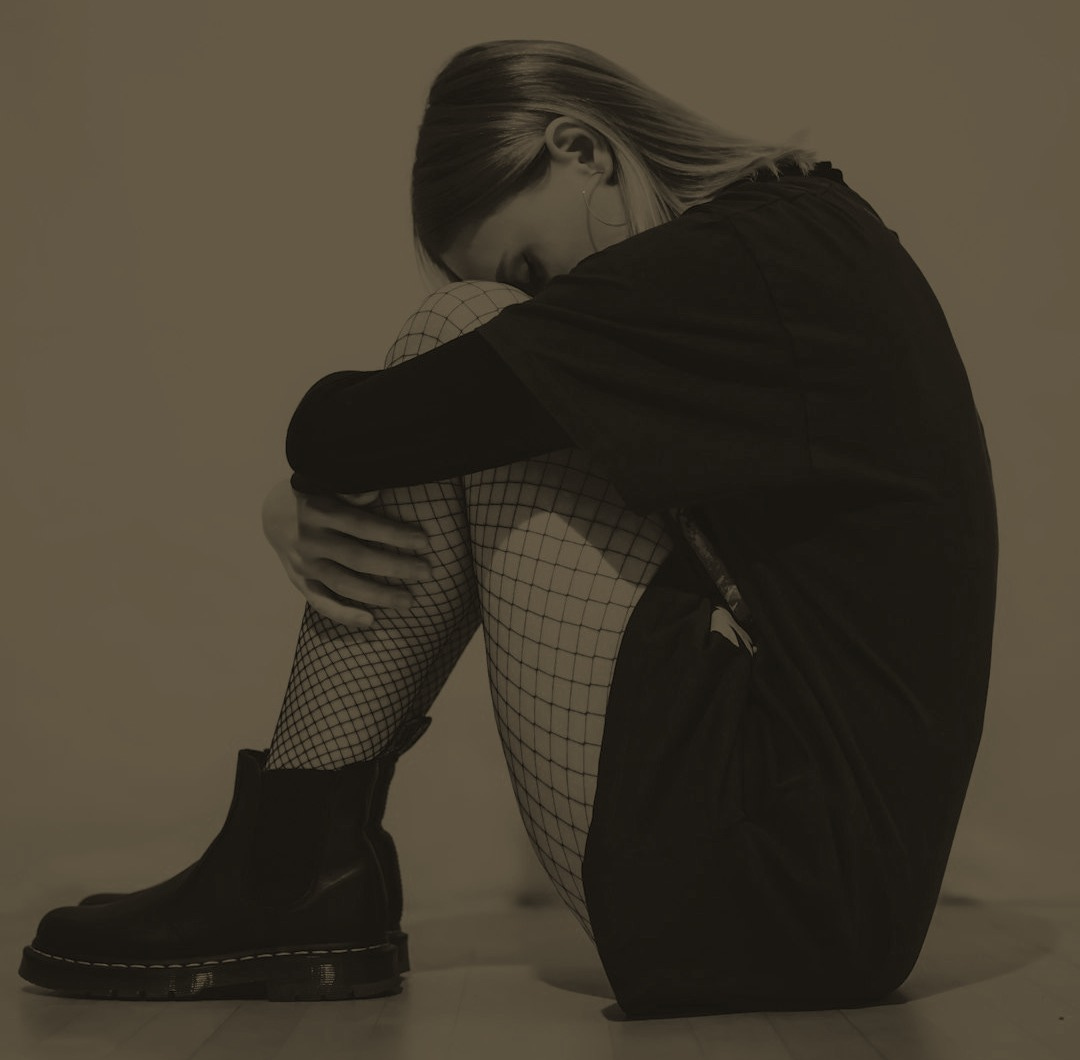 woman in black coat and black and white checkered pants