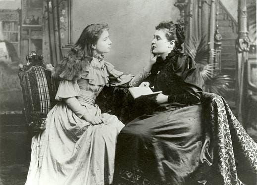 Helen Keller and Anne Sullivan sitting together.