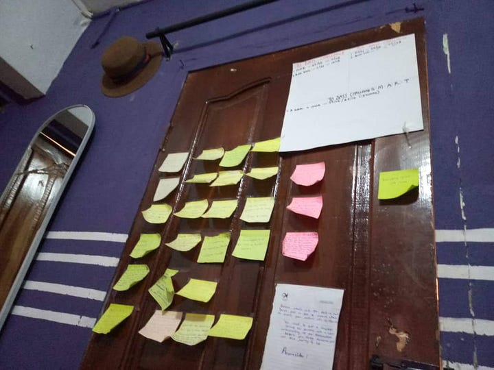 Sticking notes pasted on a board and behind a door