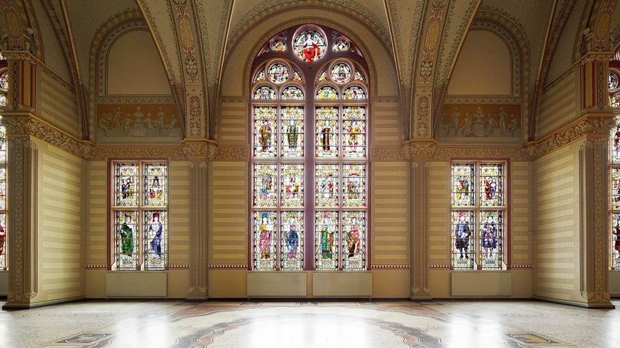 A large ornate room with stained glass windows

AI-generated content may be incorrect.