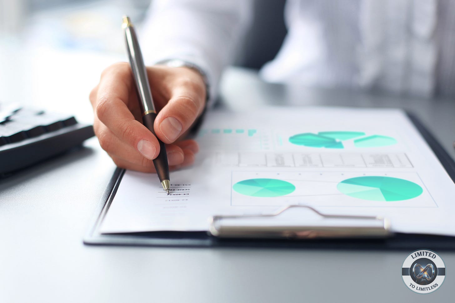 An image showing charts and a person writing