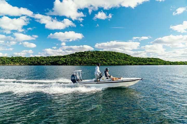 Fly-fishing guide walking the flats in The Berry Islands. Lodge owner Kyle Schaefer in a flats skiff.