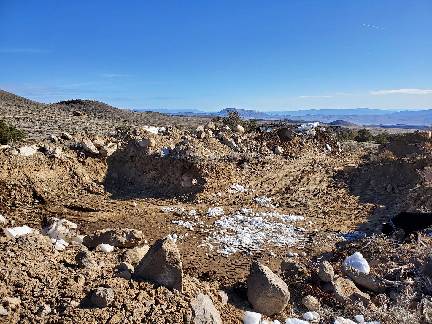 A view of a large excavated hole in the ground.
