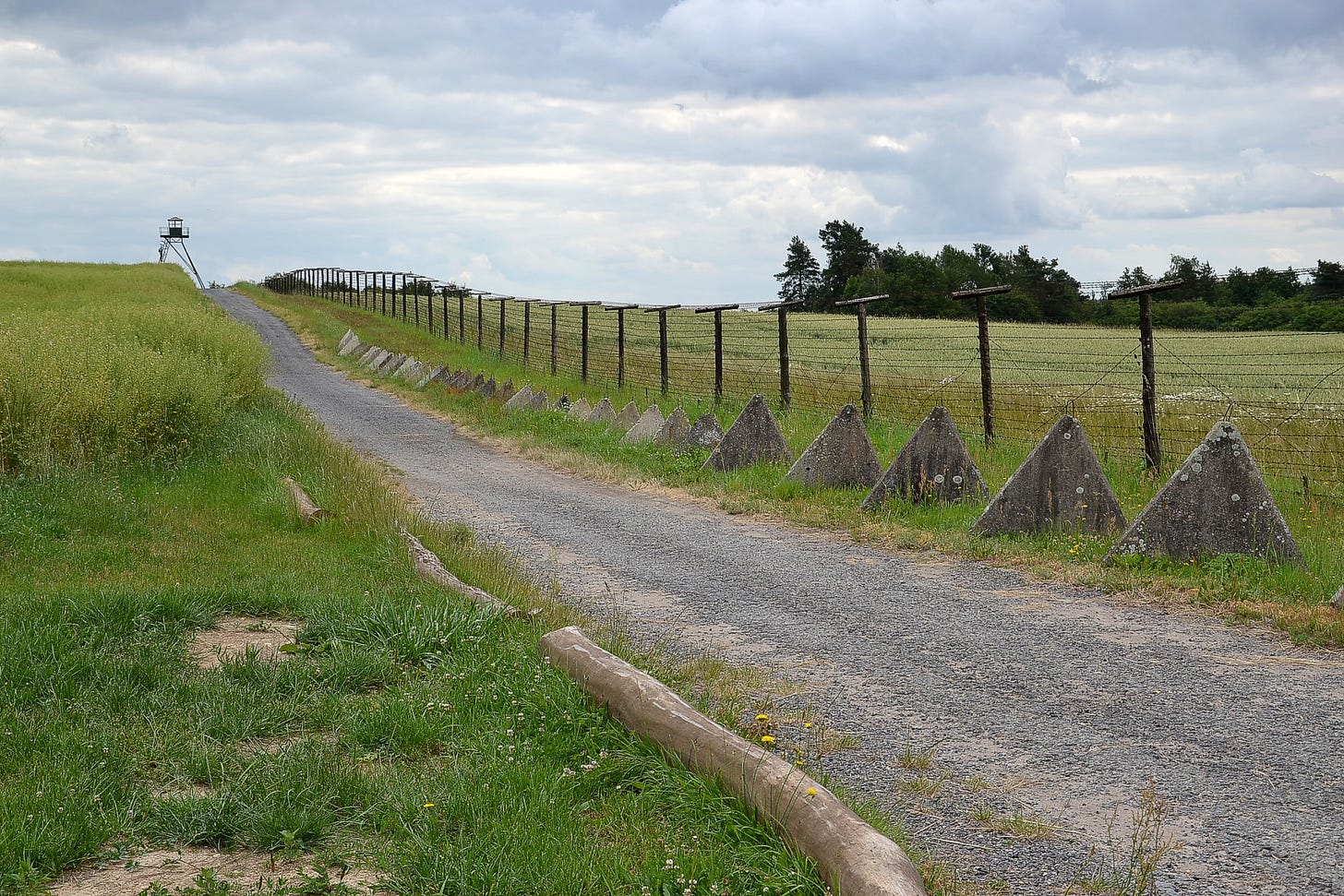 Preserved part of "iron curtain" in the Czech Republic. A watchtower, dragon's teeth and electric security fence are visible. - Wikipedia