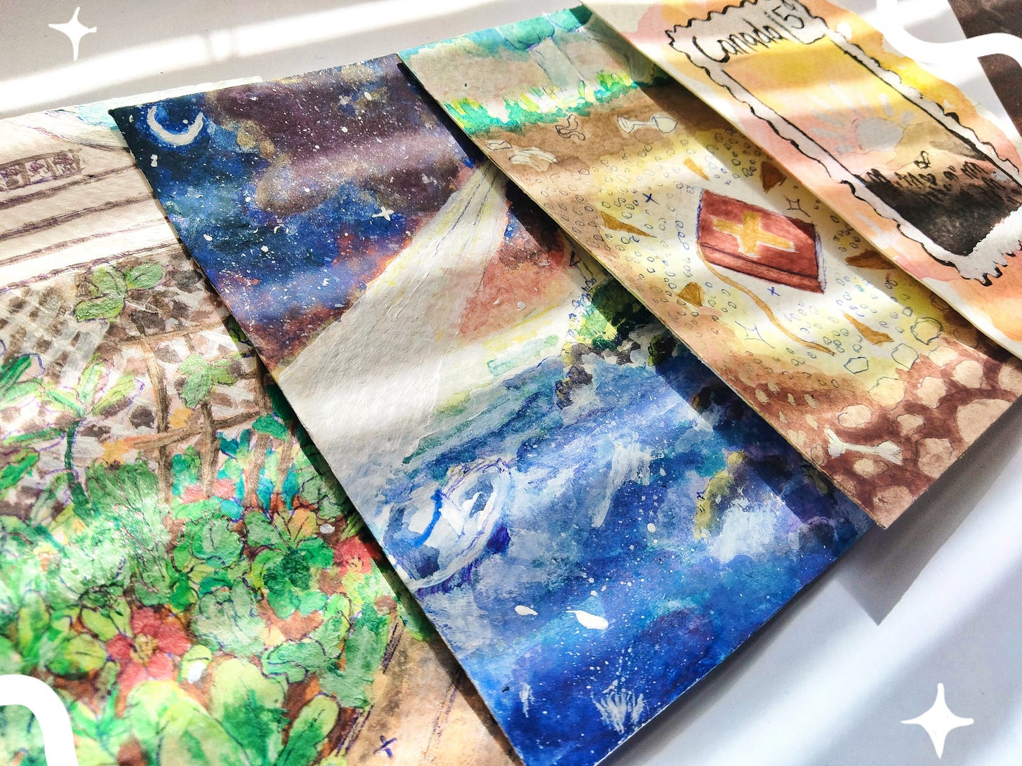 4 small colorful pieces of artwork