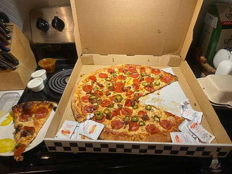 Left to right: clothes hanging on a line in a backyard, Anthony in a floral button down and Equis, a small black dog walking with roses on the right and trees in the background, a pepperoni and jalepeno pizza sitting on a stove top with the box open