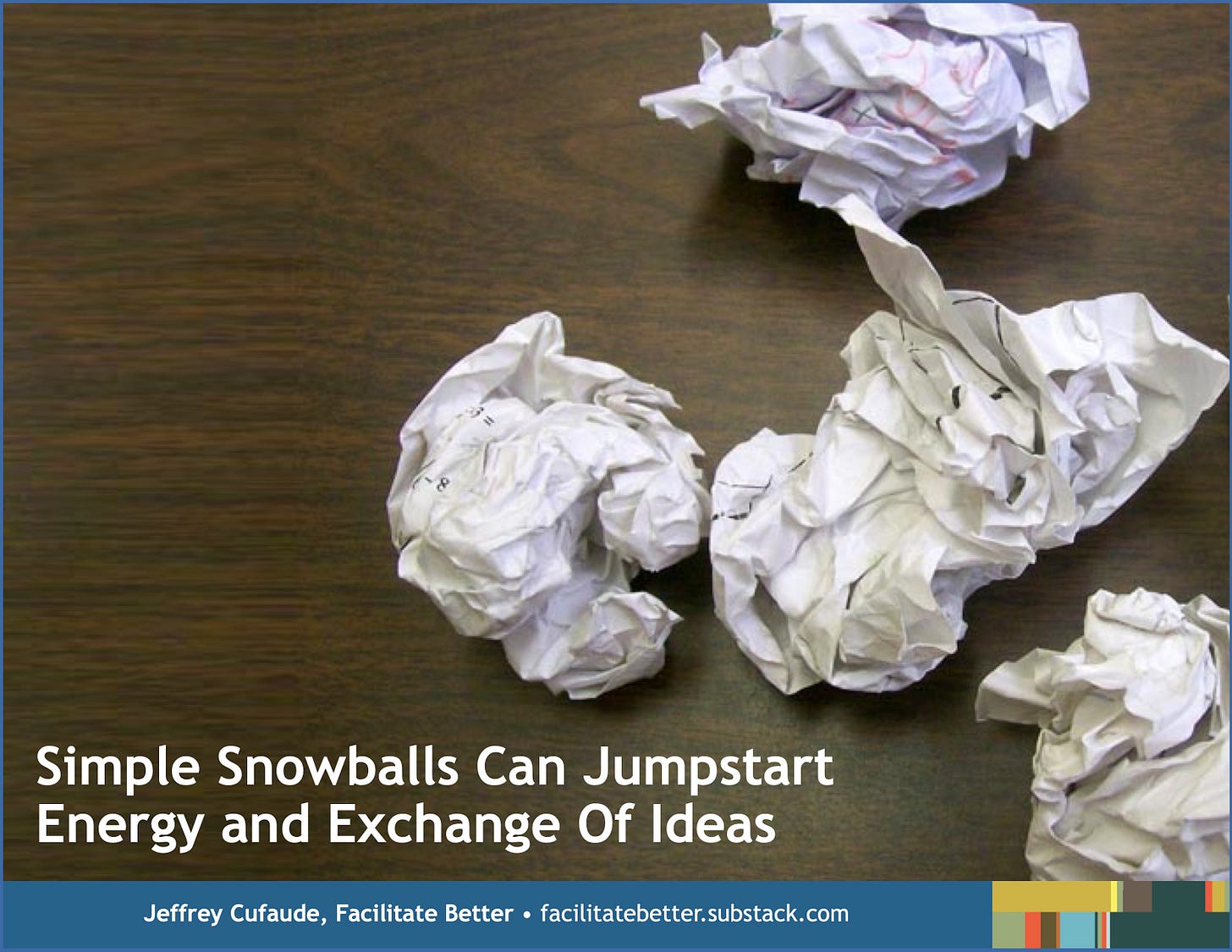 four crumpled sheets of white paper sitting on a desktop