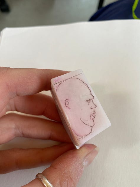man carved out of pink opal