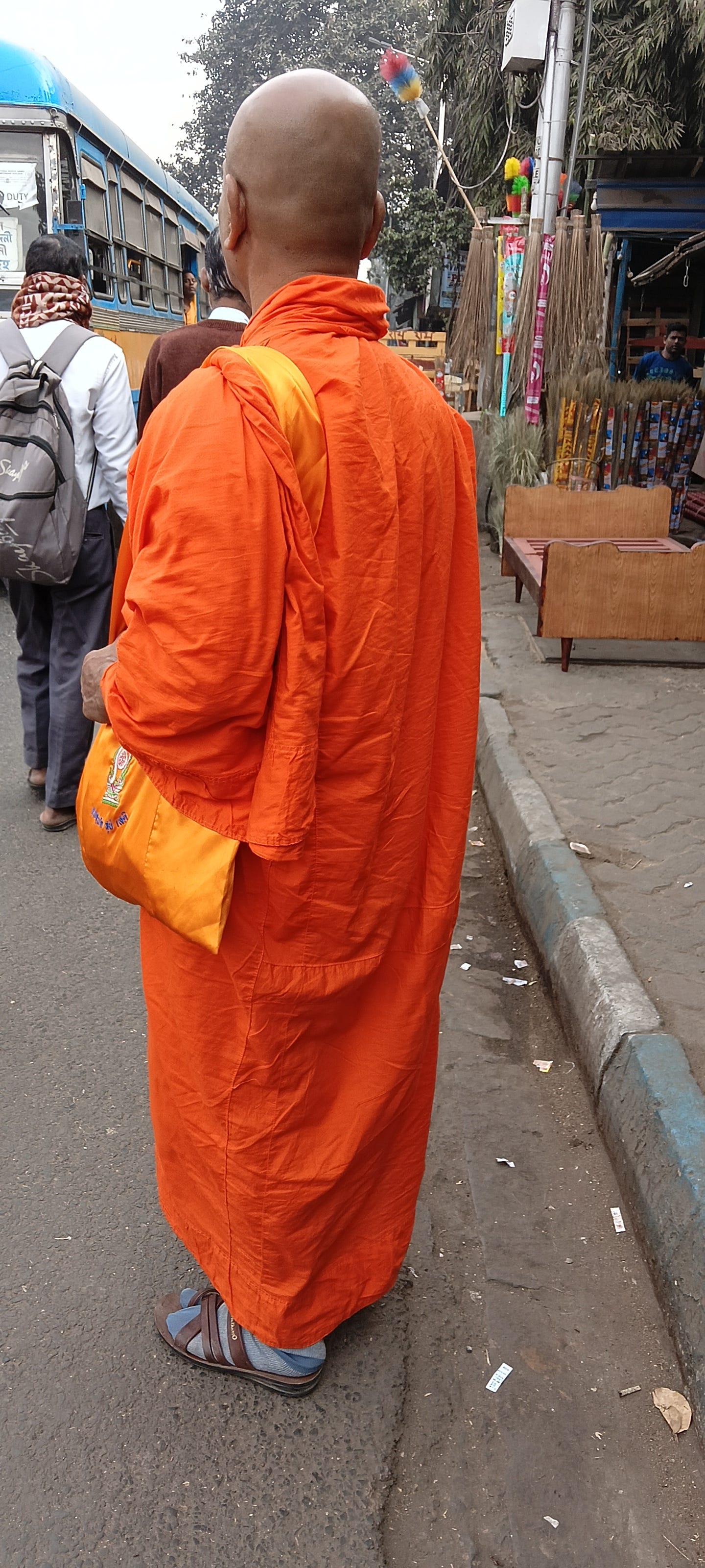Buddhist monk wearing a saffron colored robe Buddhist monk wearing a saffron colored robe