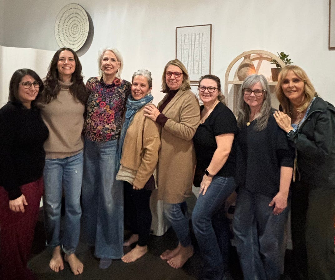 Ten women standing together posing