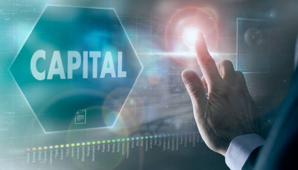 A businessman controlling a futuristic display with a Capital on it. A businessman controlling a futuristic display with a Capital business concept on it. VCs stock pictures, royalty-free photos & images