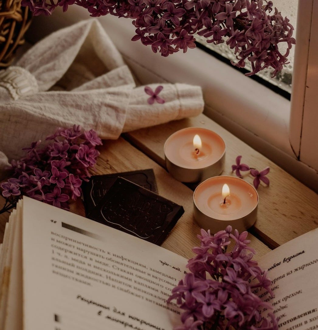 white candle beside white book white candle beside white book