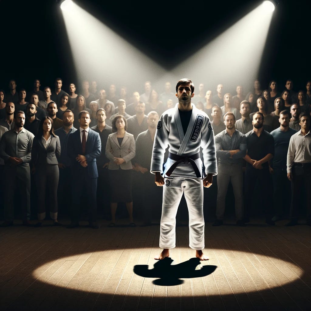 A man in a white Brazilian jiu jitsu gi with a white belt, signifying he is a beginner, standing center stage among a crowd. A spotlight shines on him as he holds a sign that says 'I'm different'. The crowd is in shadow, with their attention focused on the man. The stage is simple, with a wooden floor and a dark background, emphasizing the spotlight on the man.