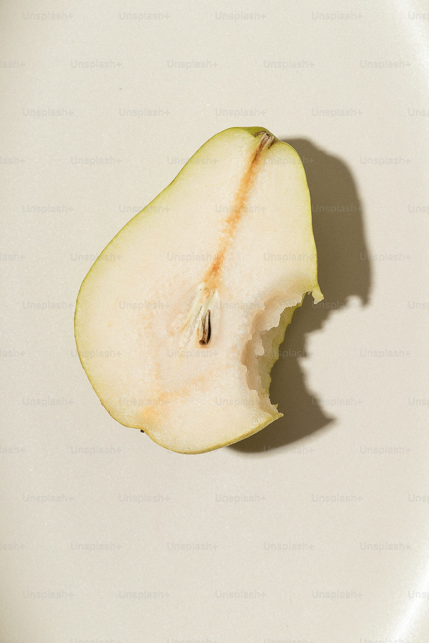 a half eaten apple sitting on top of a white plate