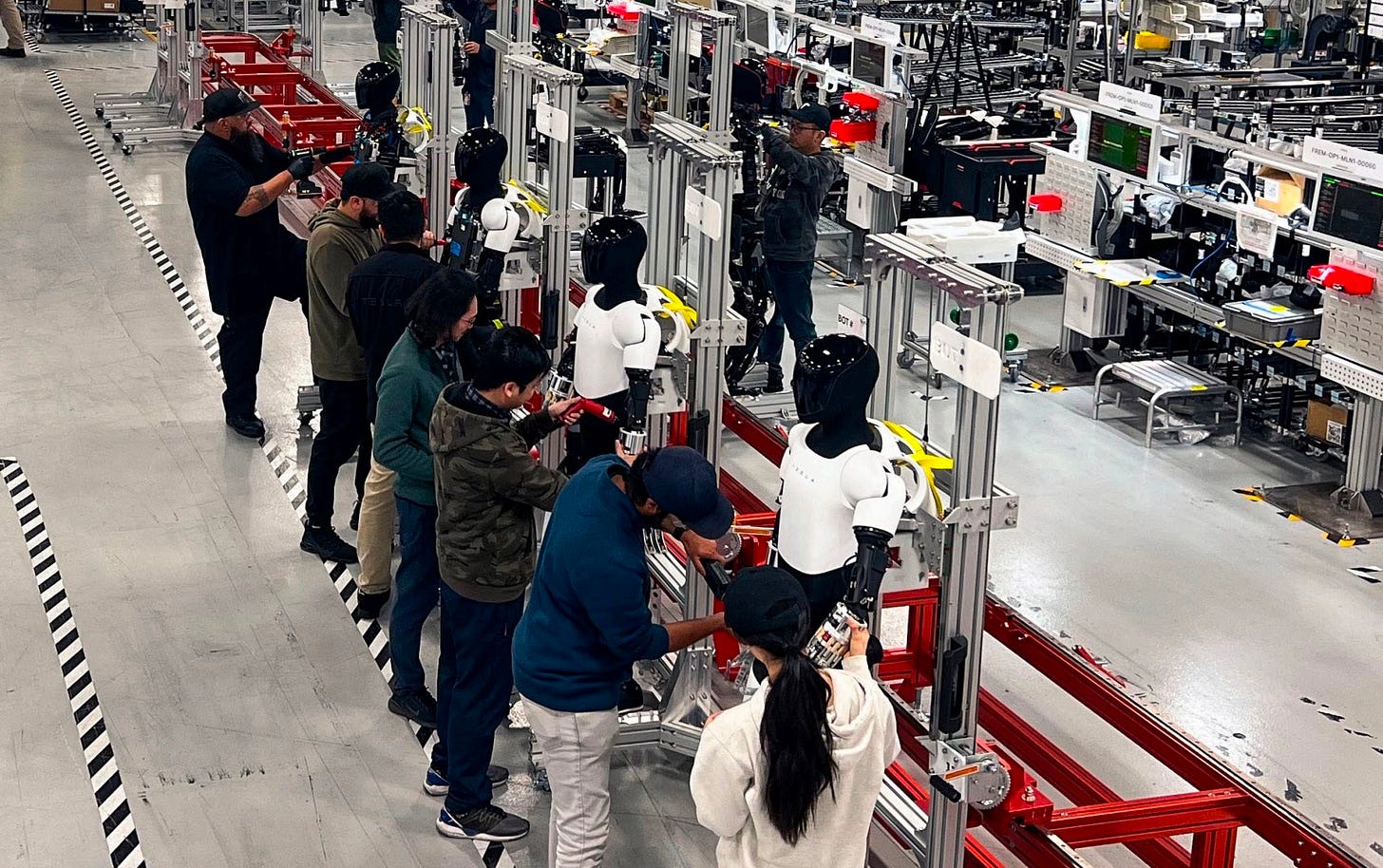 Tesla Optimus units line up in Fremont's pilot production line Tesla Optimus units line up in Fremont's pilot production line
