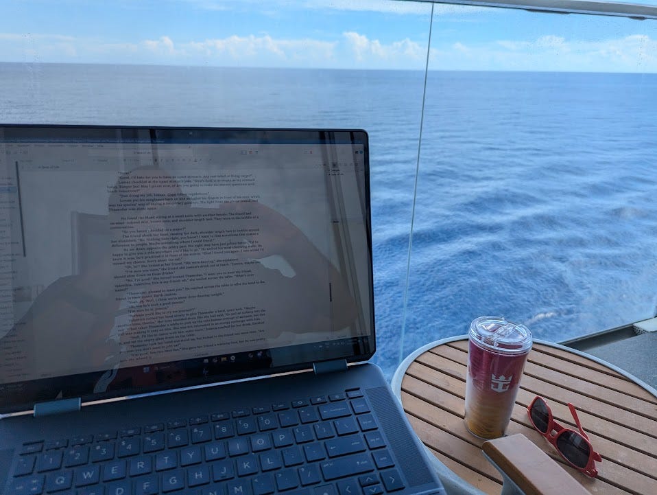A laptop on a cruise ship balcony with the sea in the background