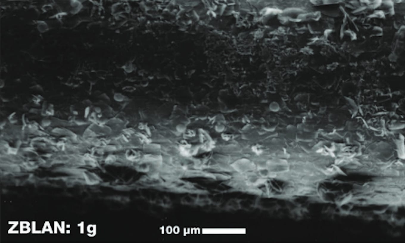 This top image shows a highly magnified fiber with a surface covered in multiple flakes and bumps. This top image shows a highly magnified fiber with a surface covered in multiple flakes and bumps.