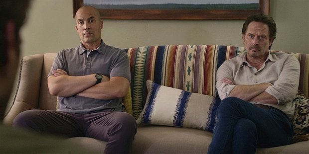 Walker James family sitting on couch arms crossed watching tv not talking. Walker James family sitting on couch arms crossed watching tv not talking.