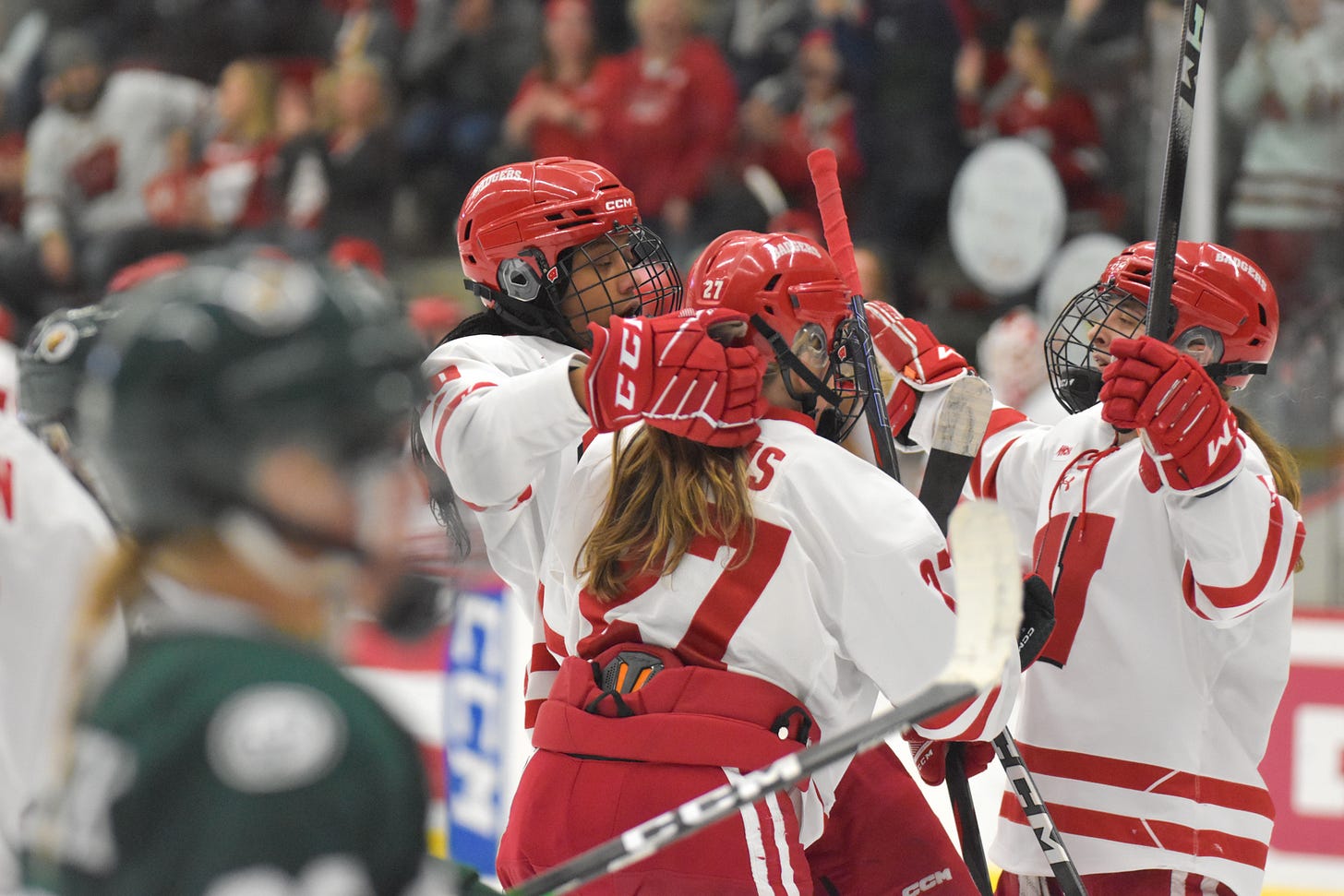 Badgers women's hockey players meet for a group hug