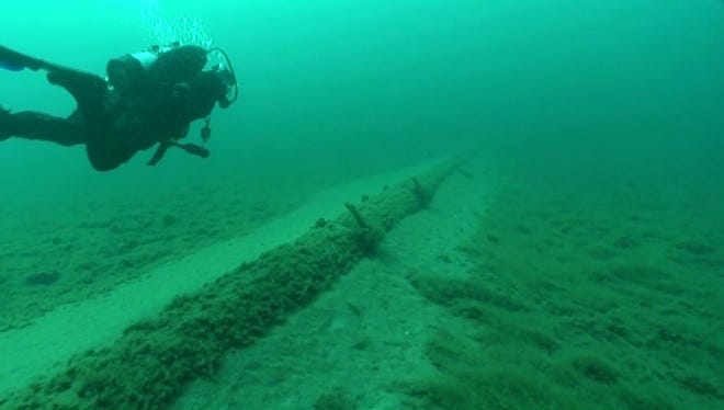 A diver working on behalf of the nonprofit National Wildlife Federation inspects the Line 5 oil pipelines at the lake bottom in the Straits of Mackinac during a July 2013 dive.