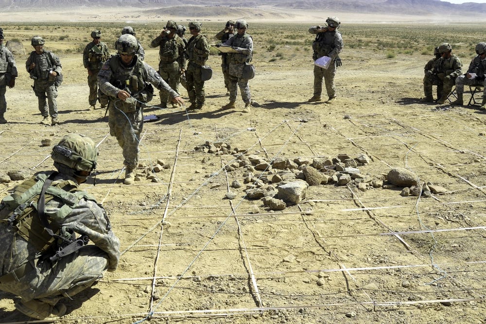 Soldiers with the 2d Battalion, 137th Infantry Regiment, Kansas Army National Guard, prepare a tactical terrain model prior to a combined-arms rehearsal June 3, 2017, during a rotation of Mississippi's 155th Armored Brigade Combat Team at the National Training Center. A terrain model is used to plan attacks and maneuvers while in a tactical environment. Soldiers with the 2d Battalion, 137th Infantry Regiment, Kansas Army National Guard, prepare a tactical terrain model prior to a combined-arms rehearsal June 3, 2017, during a rotation of Mississippi's 155th Armored Brigade Combat Team at the National Training Center. A terrain model is used to plan attacks and maneuvers while in a tactical environment.