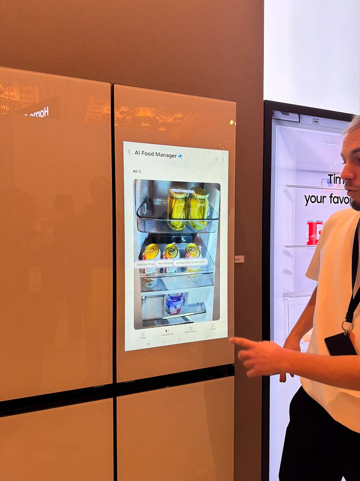 A Samsung AI Family Hub refrigerator displays a recipe for Crispy Caprese Tomato Tart on its touchscreen, while a person points to the ingredient list.