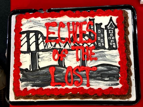 1.A cake decorated with a bridge and cityscape, with “Echoes of the  Lost” written in red across it. 2. Cindy signing books for a crowd lined up next to her. 3. Cindy holding a bunch of asparagus as if it were a bouquet,