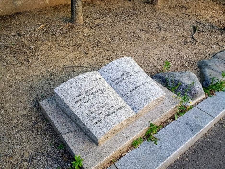 A stone book with text on it

AI-generated content may be incorrect.