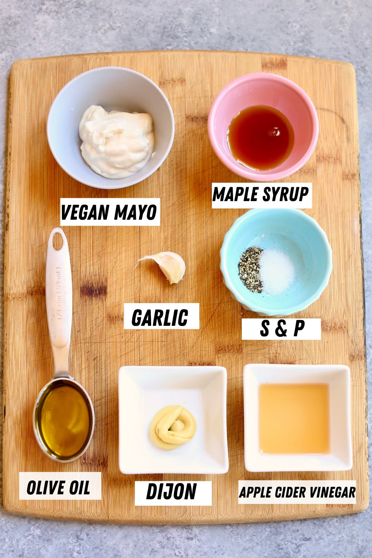a cutting board with ingredients for broccoli salad without bacon.
