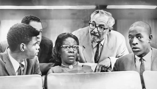 Rena Price with her son Marquette Frye, right, and stepson Ronald Frye at a hearing on the riots.