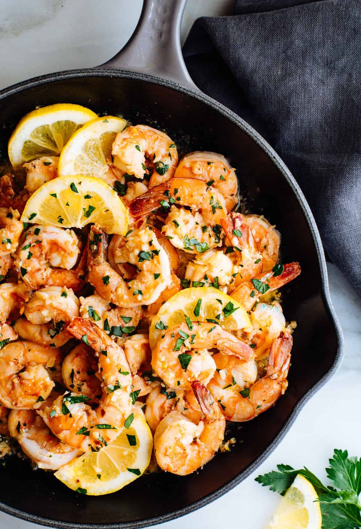 Lemon Garlic Butter Shrimp with lemon slices in a cast iron skillet