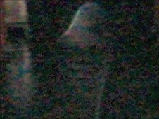 A cropped version of the photo shows something said to resemble a white cloaked figure.