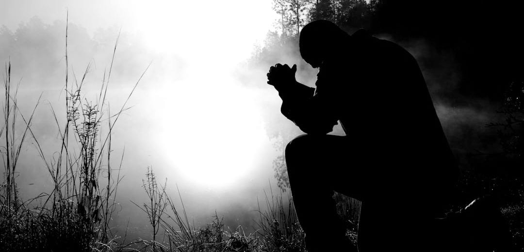 silhouette of kneeling man silhouette of kneeling man