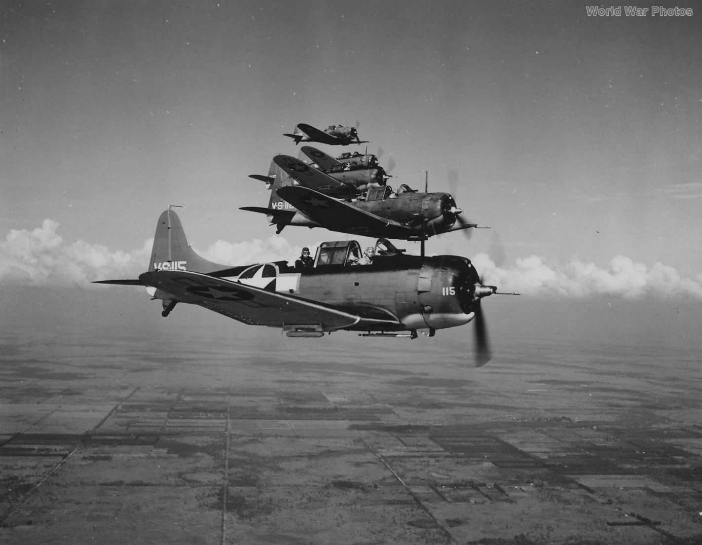 A squadron of Douglas SBD Dauntless naval scout planes fly near NAS Banana River during World War II.