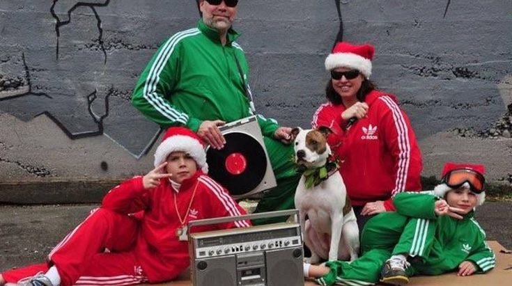 This may contain: a group of people in matching outfits posing for a photo with a dog and record player