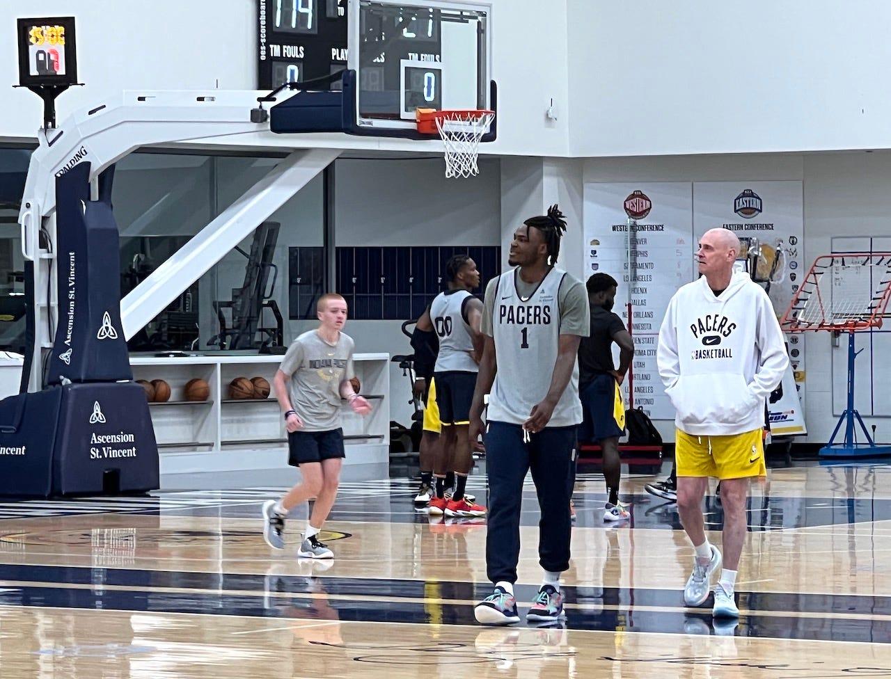 Lottery pick Jarace Walker with coach Rick Carlisle after practice.
