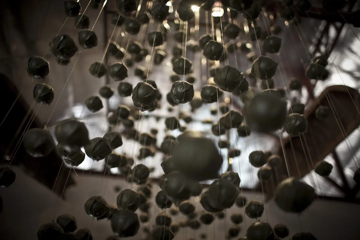 Imitation cluster bombs hang inside the Cooperative Orthotic and Prosthetic Enterprise (COPE) centre in the Laos capital, Vientiane. (Department of Foreign Affairs and Trade, Australia) Imitation cluster bombs hang inside the Cooperative Orthotic and Prosthetic Enterprise (COPE) centre in the Laos capital, Vientiane. (Department of Foreign Affairs and Trade, Australia)