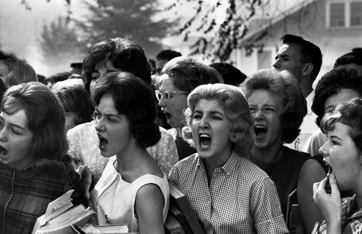 May be a black-and-white image of 4 people and crowd