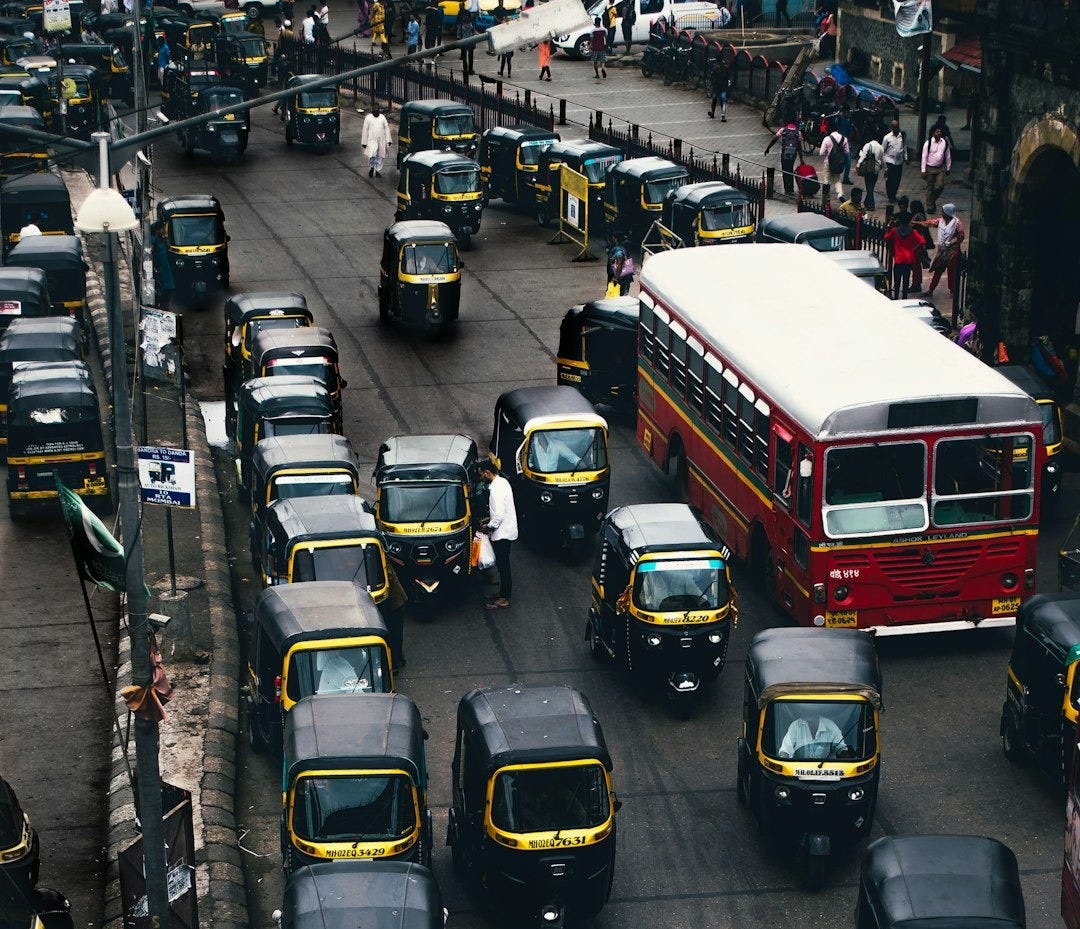 black-and-yellow auto rickshaw on road black-and-yellow auto rickshaw on road