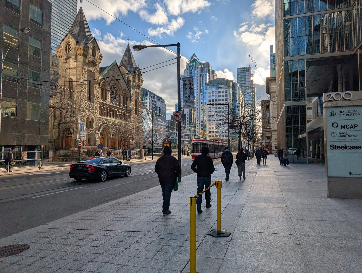 A view of Toronto's King street, Metro Hall and a streetcar are visible.